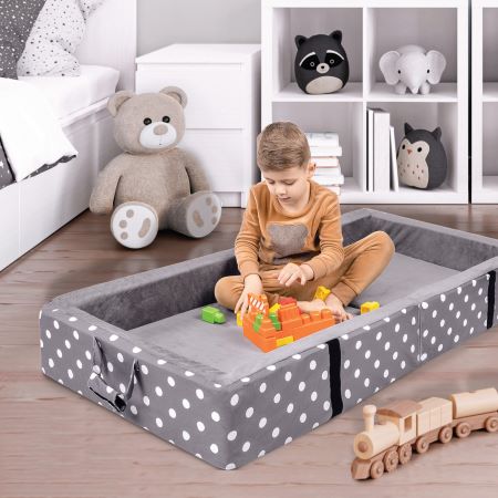 child playing in toddler bed