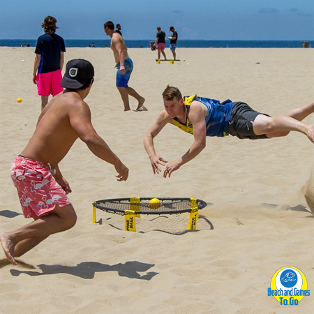 people playing spikeball on the beach